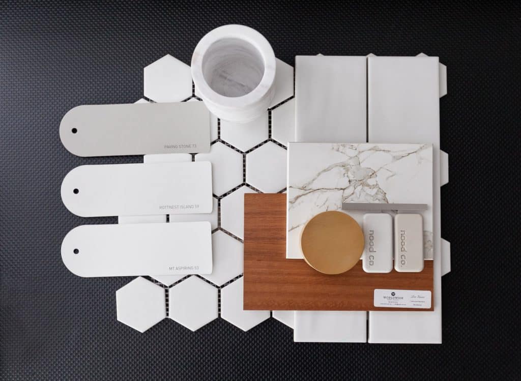 Brass and white colour flat-lay