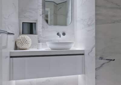 white bathoom vanity with marbled feature