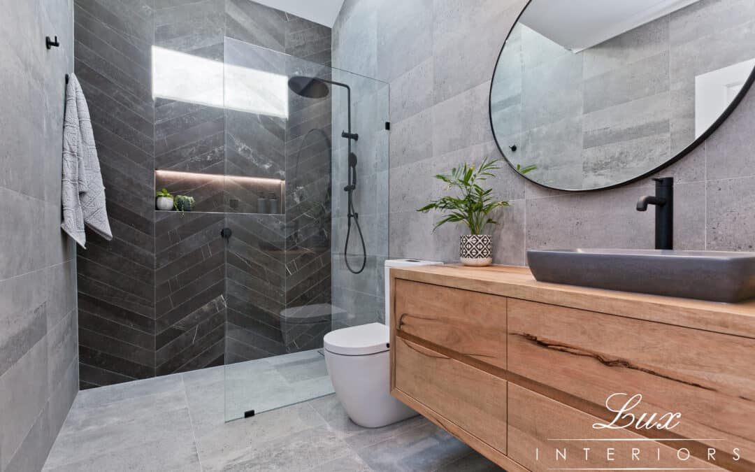 renovated bathroom located in St James with large circular mirror