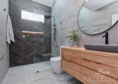 renovated bathroom located in St James with large circular mirror