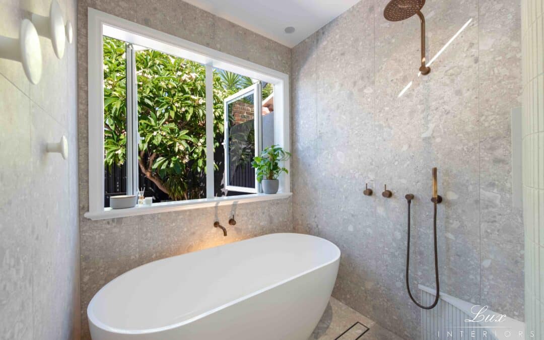 well-lit bathroom with large open window and deep bath