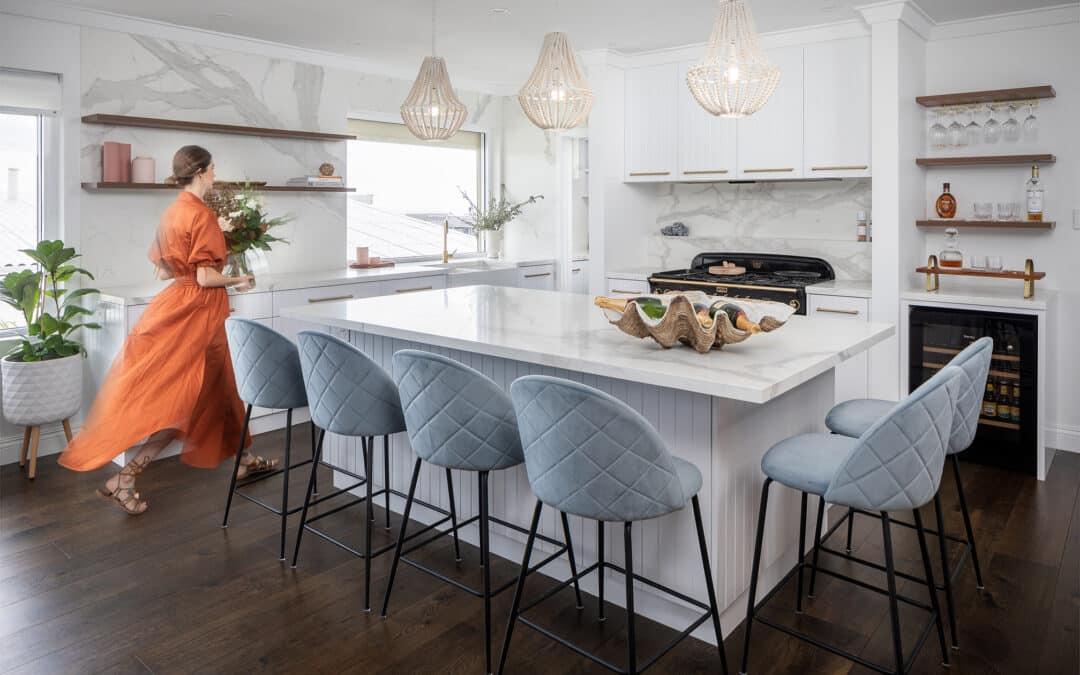 woman standing in a fully renovated kitchen