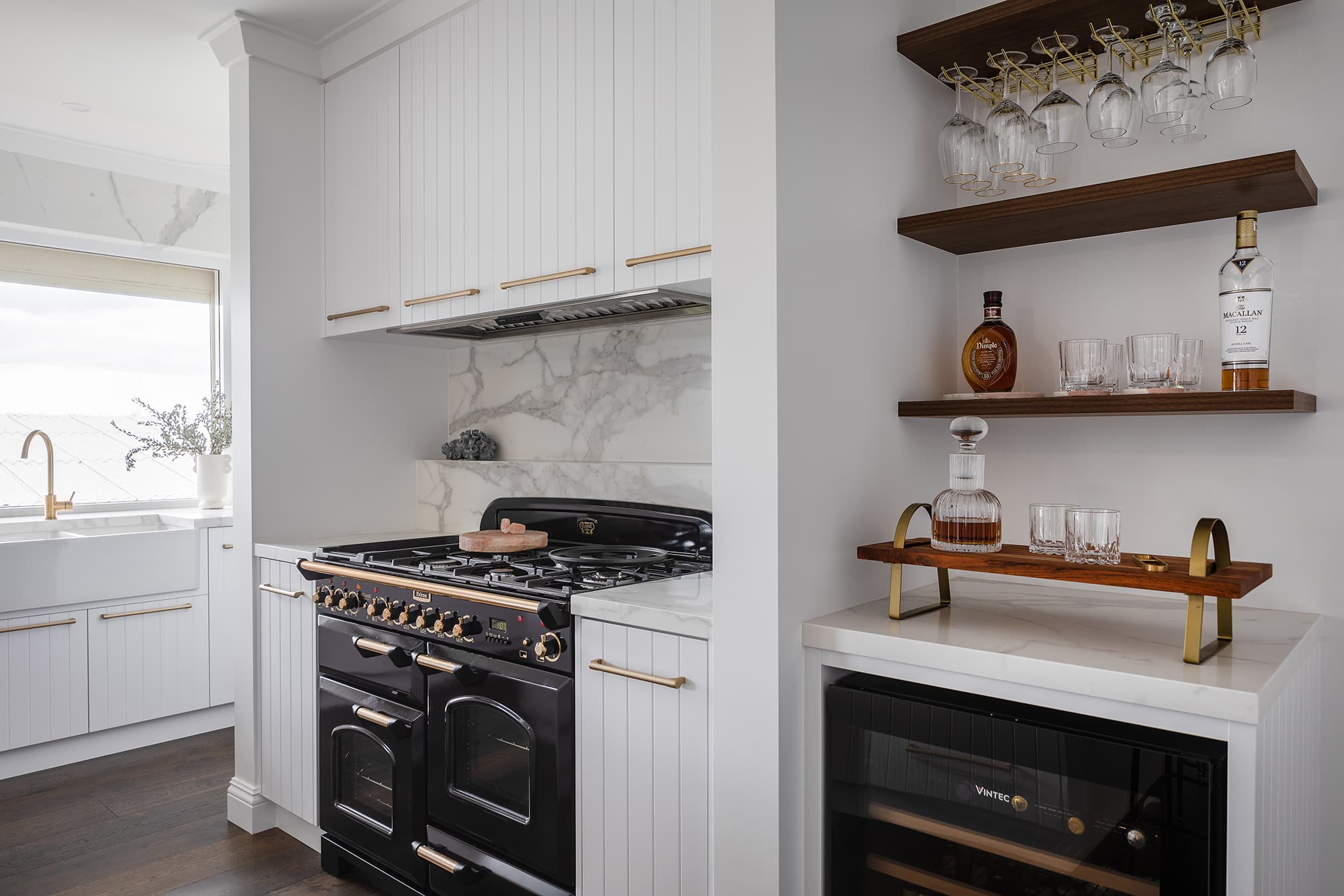 North beach coastal barn kitchen close up of feature falcon oven in black with porcelain stone tile splashback and v groove cabinetry below and above.