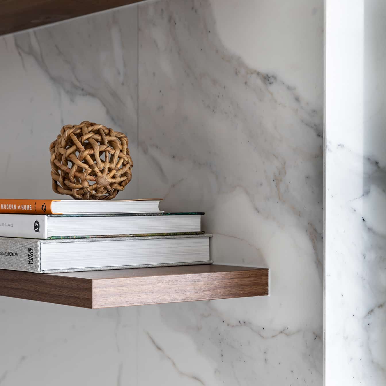 North beach coastal barn kitchen with vein matched porcelain tiles and dark timber floating shelves