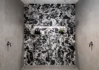 Scarborough Ensuite with striking black and white patterned tile shower wall