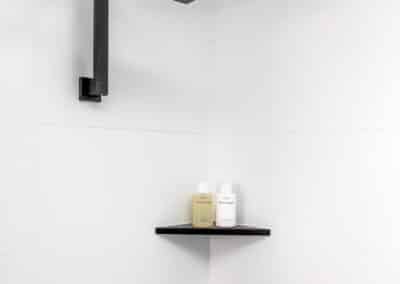 Monochrome main bathroom shower shelves