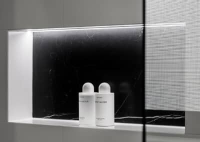 Monochrome Ensuite black stone look feature panel in shower niche