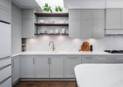 Contemporary shaker style kitchen with brass tapware and floating shelves