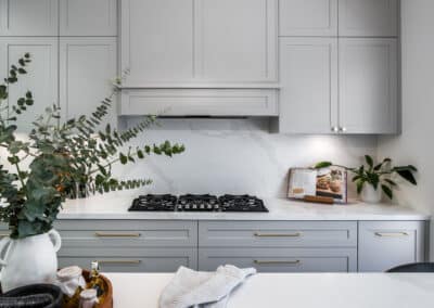 Contemporary shaker style kitchen with brass tapware and feature rangehood