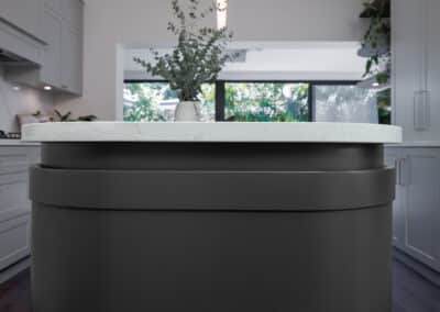 contemporary shaker style kitchen with curved island bench