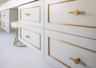 Contemporary bathroom renovation, double vanity with makeup desk, brass cabinetry details