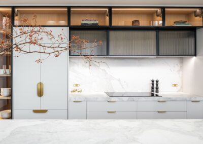 Contemporary kitchen with oak timber cabinetry, fluted glass, brass hardware and marble benchtops.