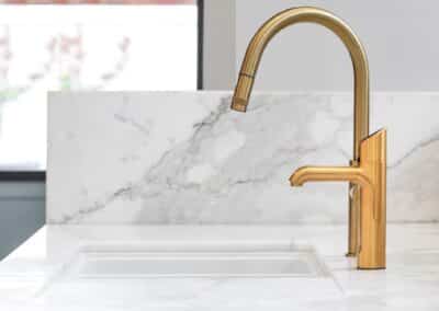 Marble benchtop with brass tapware and gold Zip tap