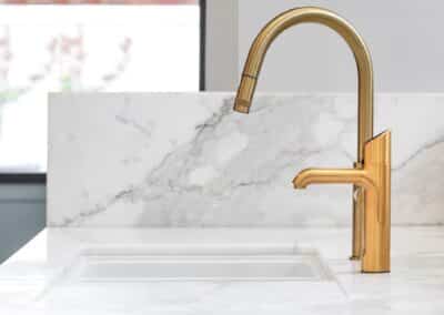 Marble benchtop with brass tapware and gold zip tap