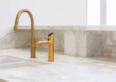 Marble benchtop with brass tapware and gold zip tap