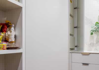 Walk in pantry with hidden tall cabinetry