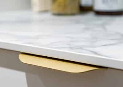 Walk in pantry with marble benchtops and brass hardware