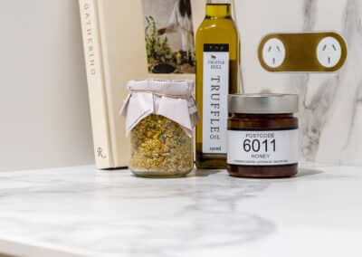 Walk in pantry with marble benchtops and brass hardware, including flush brass GPOS