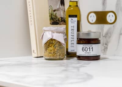 Walk in pantry with marble benchtops and brass hardware, including flush brass gpos