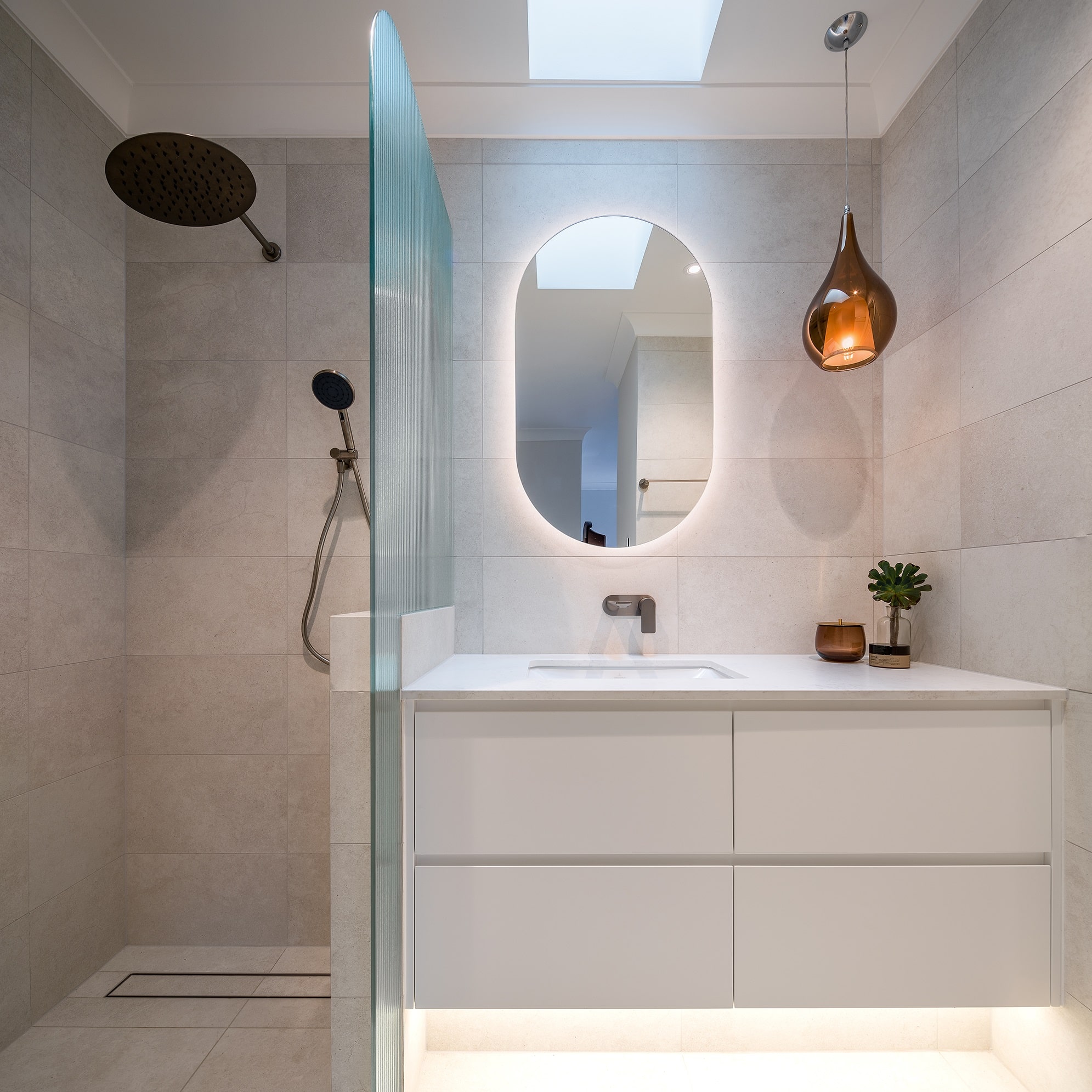 Contemporary ensuite renovation with nods to the traditional home, featuring bronze pendant light