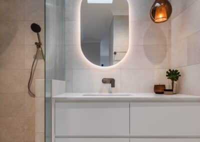 Contemporary ensuite renovation with nods to the traditional home, featuring bronze pendant light