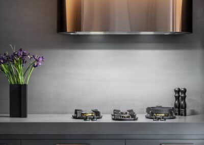 Industrial style kitchen renovation with bronze rangehood