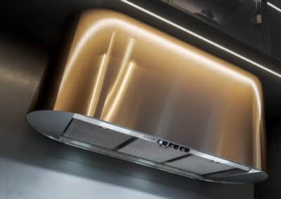 Industrial style kitchen renovation with bronze rangehood