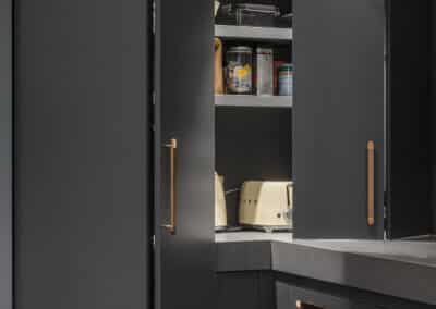 Industrial style kitchen renovation with hidden mini butler's pantry with pocket doors