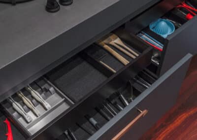 Industrial style kitchen renovation with black drawers and storage inserts