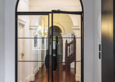 Industrial style kitchen renovation with curved black aluminium internal french doors