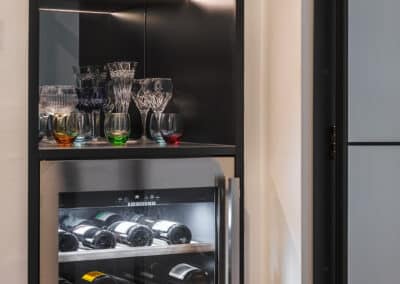 Industrial style kitchen renovation with black mirrored bar