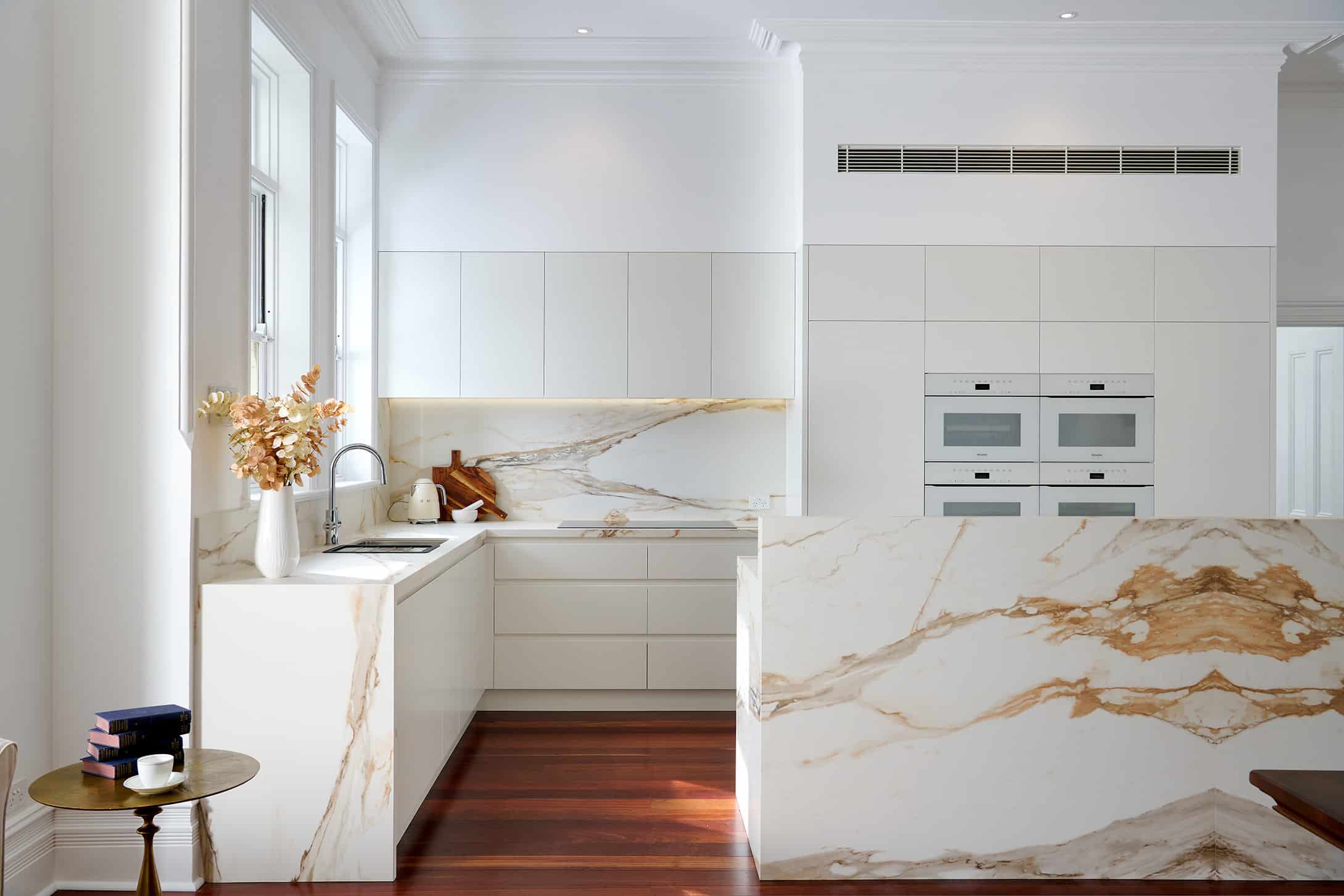 Riley Project kitchen renovation with seamless minimalist cabinetry design and a marble look bookmatched island bench