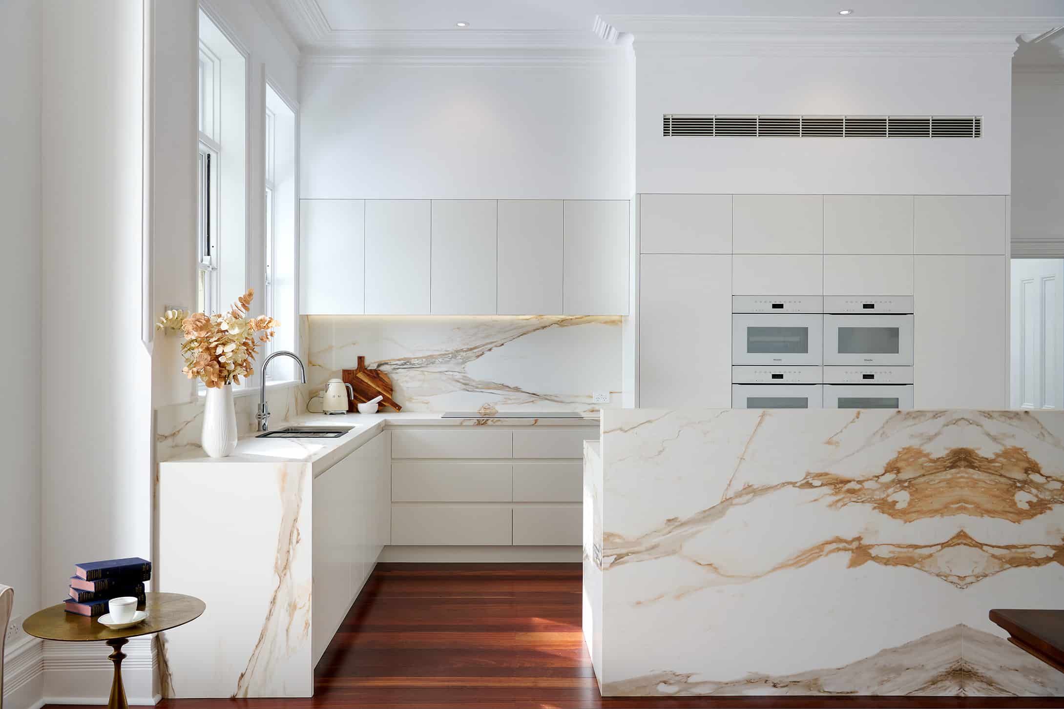 Riley project kitchen renovation with seamless minimalist cabinetry design and a marble look bookmatched island bench