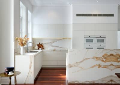 Riley project kitchen renovation with seamless minimalist cabinetry design and a marble look bookmatched island bench