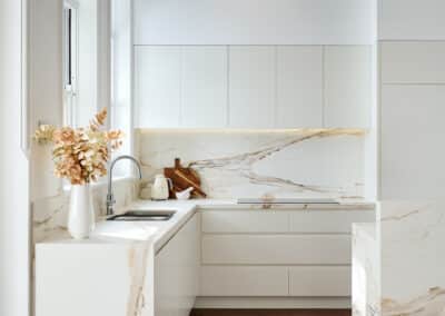 Riley project kitchen renovation with seamless minimalist cabinetry design and a marble look bookmatched island bench close up