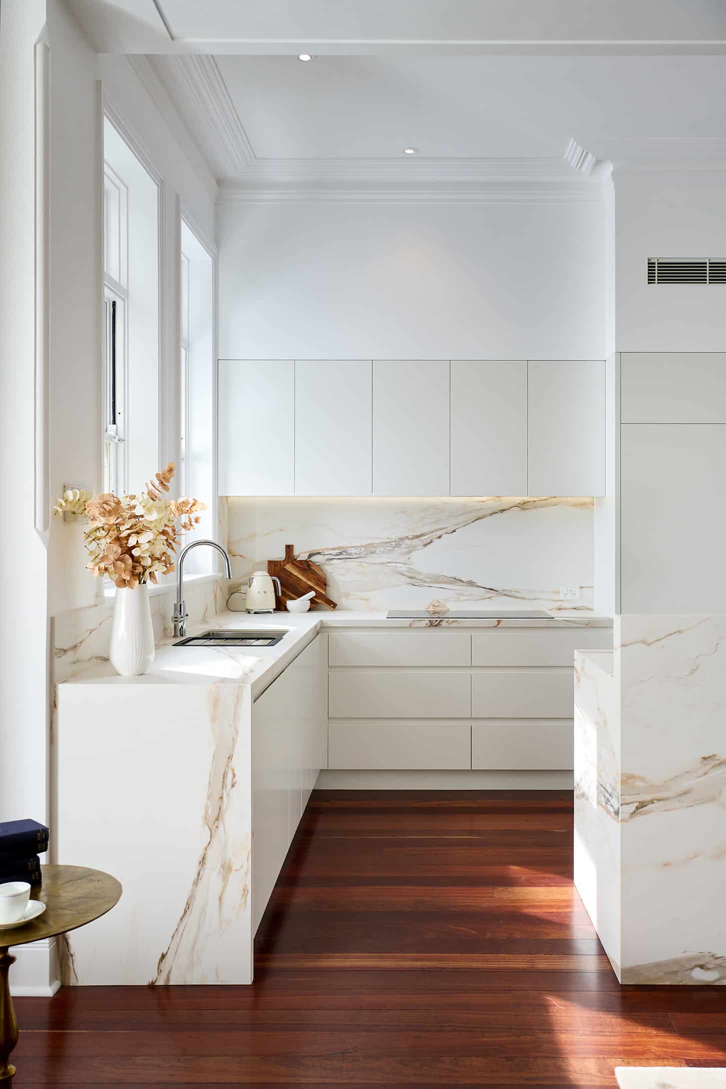 Riley project kitchen renovation with seamless minimalist cabinetry design and a marble look bookmatched island bench close up