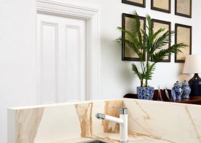 Riley Project kitchen renovation with seamless minimalist cabinetry design and a marble look bookmatched island bench close up on sink in island