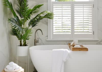 Contemporary marble look upstairs bathroom close up of bath under window