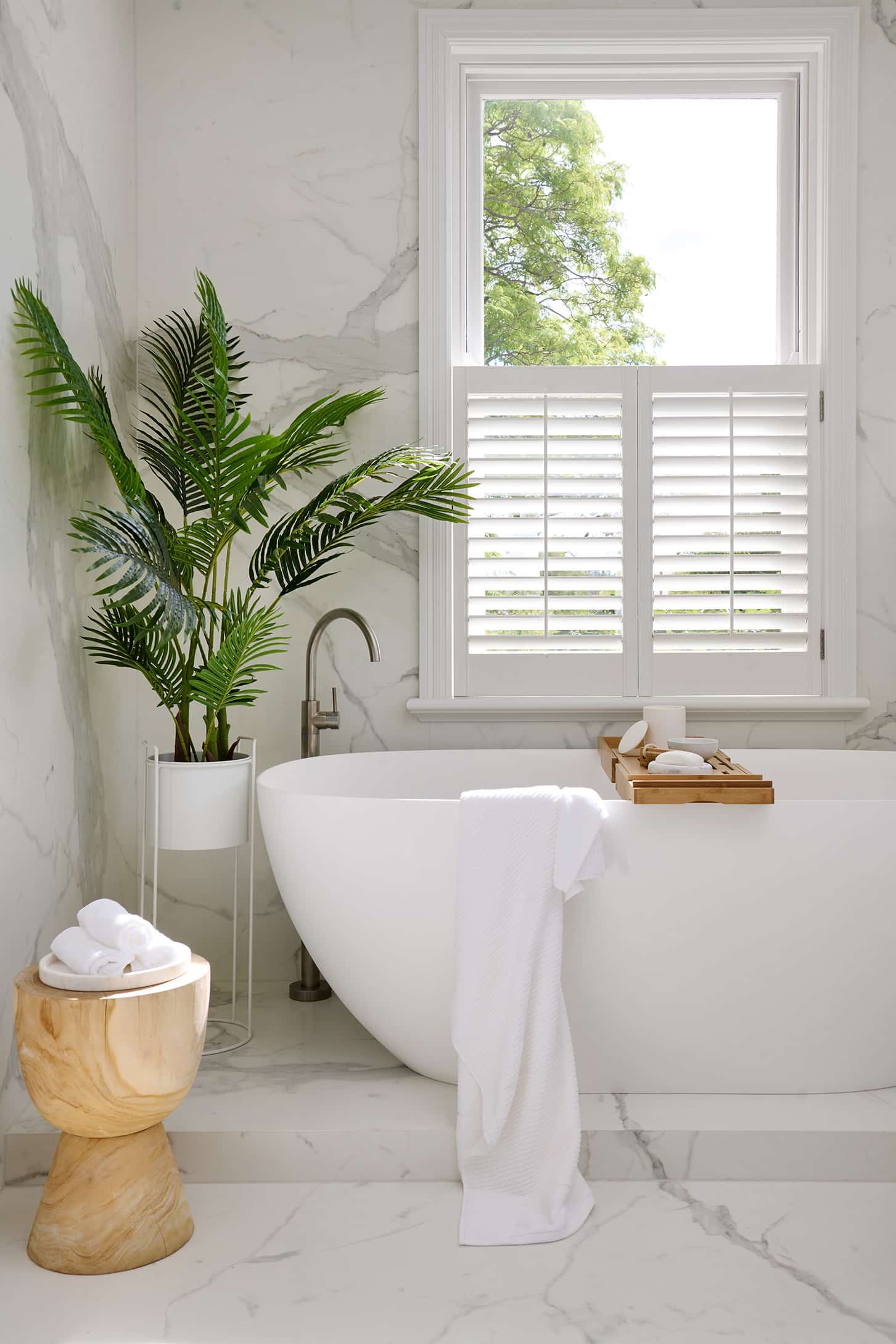 Contemporary marble look upstairs bathroom close up of bath under window