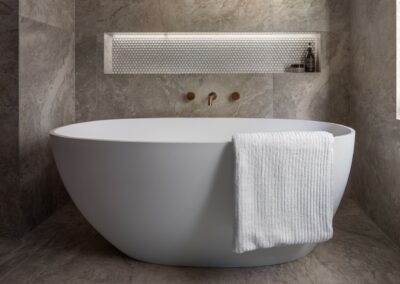 Mid-century modern contemporary ensuite reno with free standing bath, bronze tapware and recessed niche