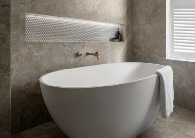 Mid-century modern contemporary ensuite reno with free standing bath, bronze tapware and recessed niche on an angle