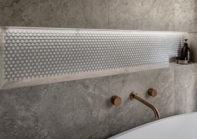 Mid-century modern contemporary ensuite reno with free standing bath, bronze tapware and recessed niche close up