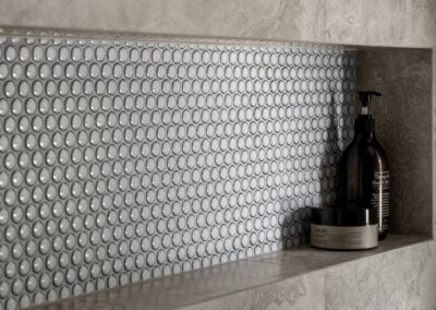 Close up of bath niche with penny round tiles