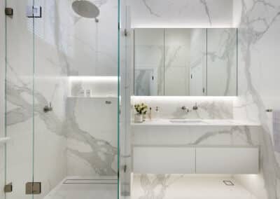 Contemporary marble look downstairs ensuite of shower and vanity