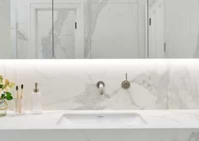 Contemporary marble look downstairs ensuite vanity with mirror cabinetry