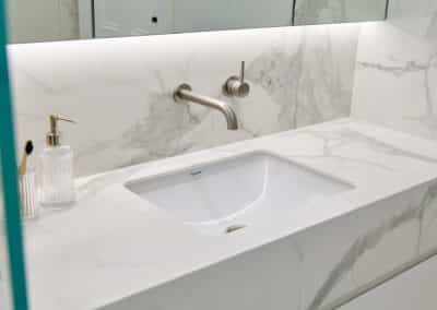 Contemporary marble look downstairs ensuite vanity sink and brushed nickel tapware