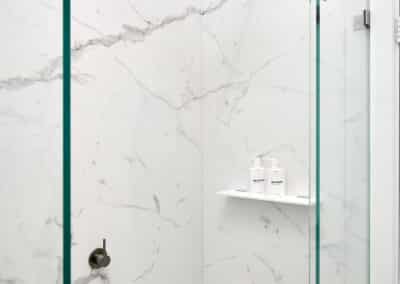 Contemporary marble look downstairs bathroom close up of shower