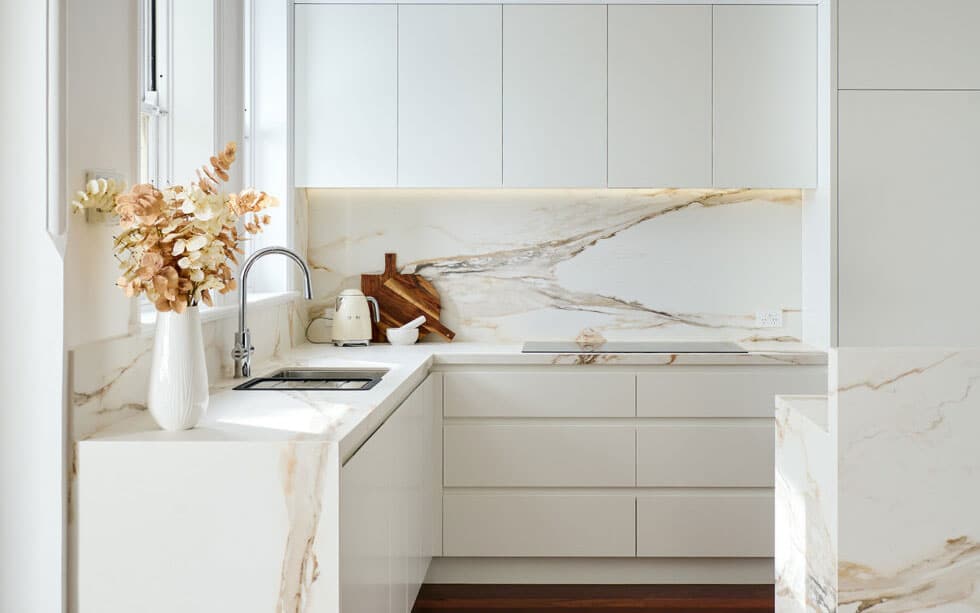 white luxury kitchen with marble backsplash