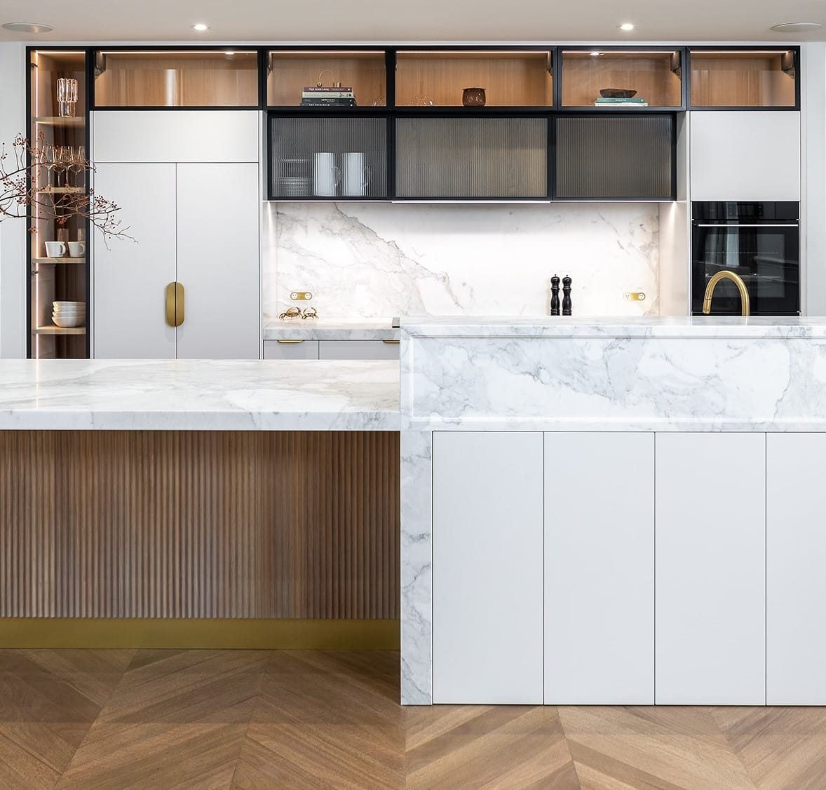 Contemporary kitchen renovation with timber scallop island, moulded stone top, fluted glass and brass details.