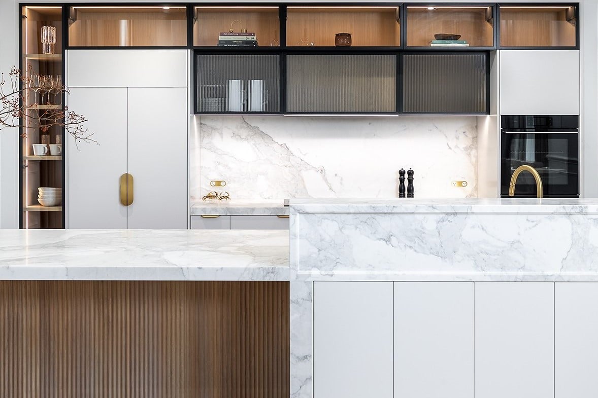 Contemporary kitchen renovation with timber scallop island, moulded stone top, fluted glass and brass details.